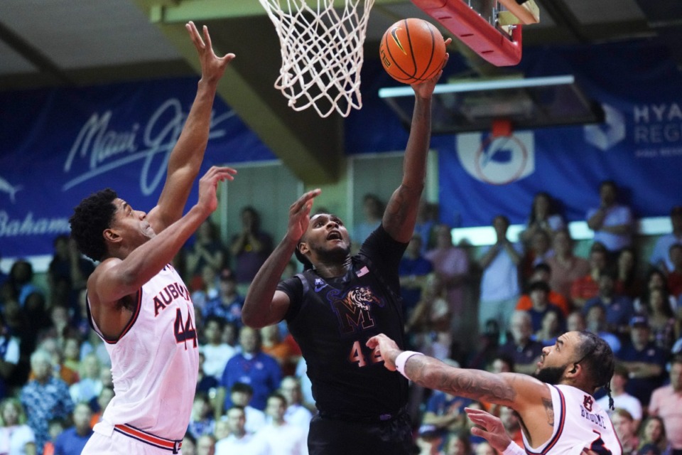 <strong>Memphis forward Dain Dainja (42) can't put it in the basket against Auburn center Dylan Cardwell, left, and forward Johni Broome, right, on Wednesday, Nov. 27, 2024, in Lahaina, Hawaii.</strong> (Lindsey Wasson/AP)