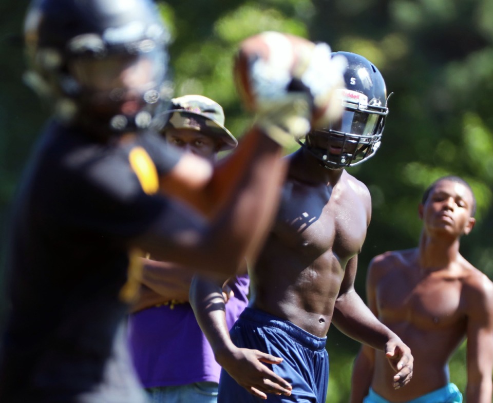 <strong>Mitchell High School quarterback Hadem Sow, center, watches as his pass is caught Wednesday, Aug. 28, while preparing for a game against KIPP the next day.</strong> (Patrick Lantrip/Daily Memphian)