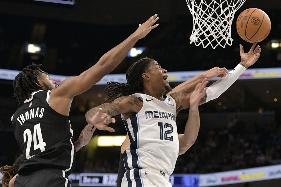 <strong>Memphis Grizzlies guard Ja Morant (12) shoots ahead of Brooklyn Nets guard Cam Thomas (24) in the first half of an NBA basketball game Wednesday, Oct. 30, 2024, in Memphis.</strong> (Brandon Dill/AP Photo file)