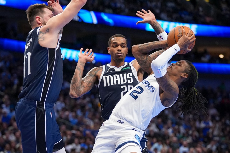 <strong>Memphis Grizzlies guard Ja Morant, right, tries to shoot as Dallas Mavericks guard Luka Doncic, left, and forward P.J. Washington defend during the first half of an Emirates NBA Cup basketball game, Tuesday, Dec. 3, 2024, in Dallas.</strong> (Julio Cortez/AP)