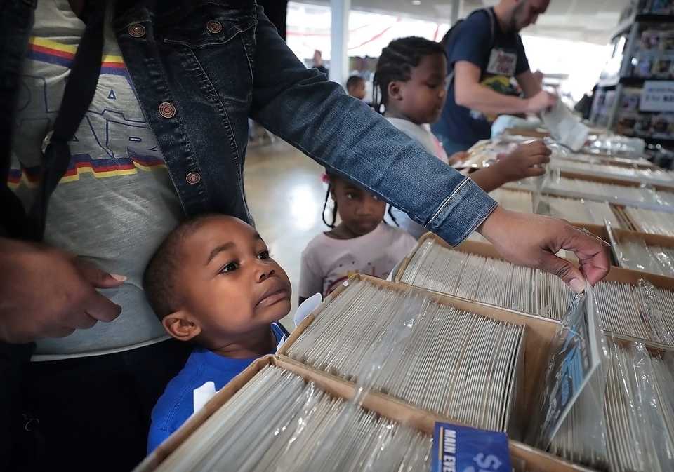 <strong>Johnson Cooley, 4, peruses comics with his mother, Kira Cooley, during the Memphis Comic Expo at the Agricenter on Oct. 20, 2019.</strong> (Jim Weber/Daily Memphian)