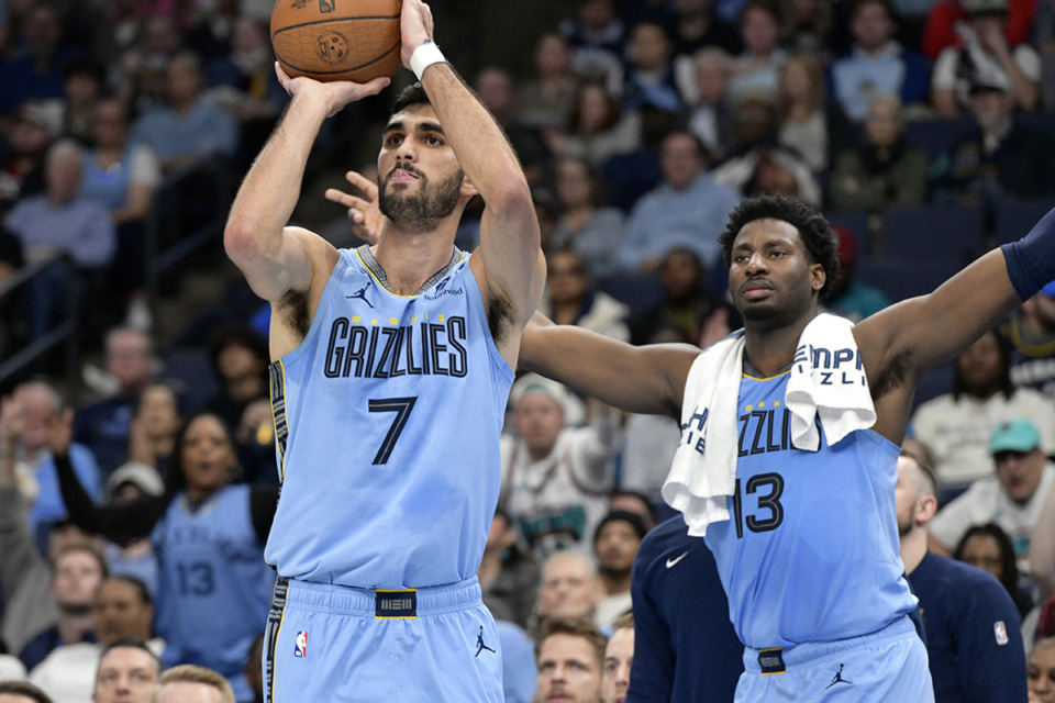 <strong>Memphis Grizzlies forward Santi Aldama (7) shoots as teammate Jaren Jackson Jr. (13) looks on from the bench in the first half of an Emirates NBA Cup basketball game against the Denver Nuggets on Tuesday, Nov. 19, in Memphis.</strong> (Brandon Dill/AP file)