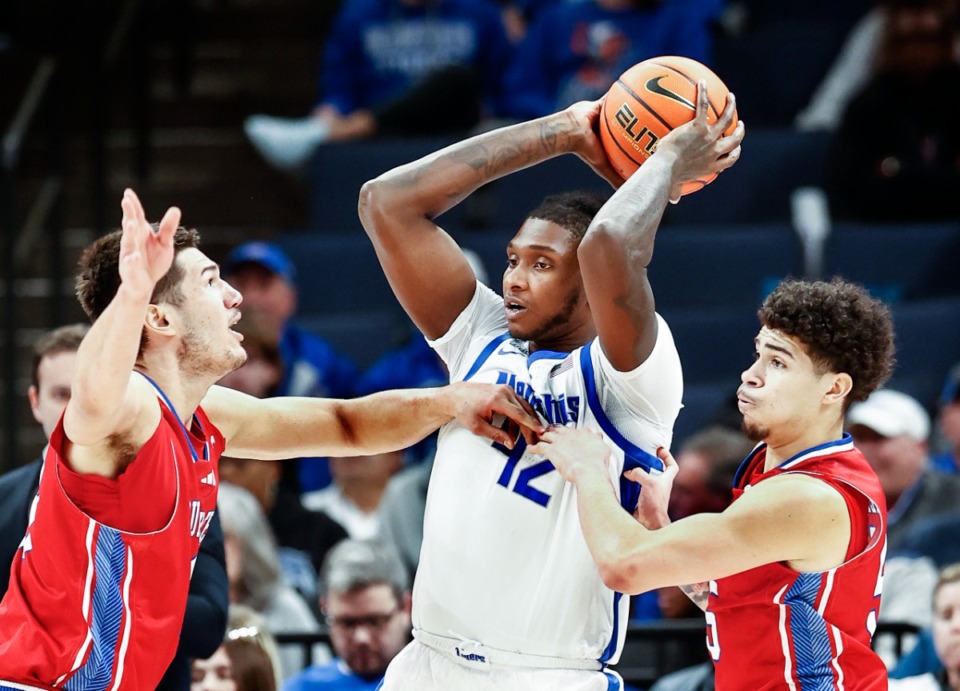 <strong>University of Memphis center Dain Dainja (middle) looks to pass around the Louisiana Tech defense on Wednesday, Dec. 4, 2024.</strong> (Mark Weber/The Daily Memphian)