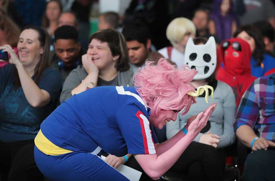 <strong>Lacy Krone protects her horns as she makes her way to the stage as anime character Mina Ashido during the cosplay contest at the Memphis Comic Expo on Oct. 20, 2019.</strong> (Jim Weber/Daily Memphian)