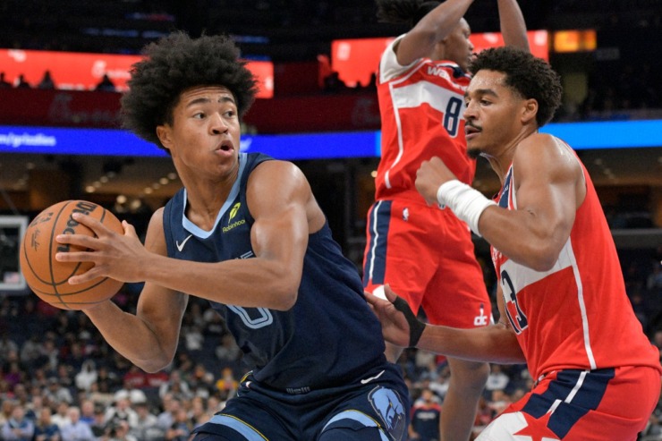 Memphis Grizzlies forward Jaylen Wells (0) handles the ball against Washington Wizards guard Jordan Poole (13) in the first half of an NBA basketball game Friday, Nov. 8, 2024, in Memphis, Tenn. (AP Photo/Brandon Dill)