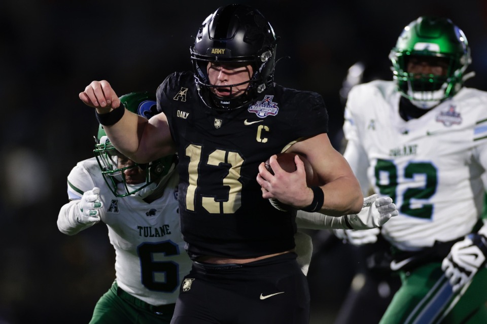 <strong>Army quarterback Bryson Daily (13) runs with the ball past Tulane defensive back Micah Robinson (6) during the second half of the American Athletic Conference championship NCAA college football game Friday, Dec. 6, 2024, in West Point, N.Y. Army won 35-14.</strong> (AP Photo/Adam Hunger)