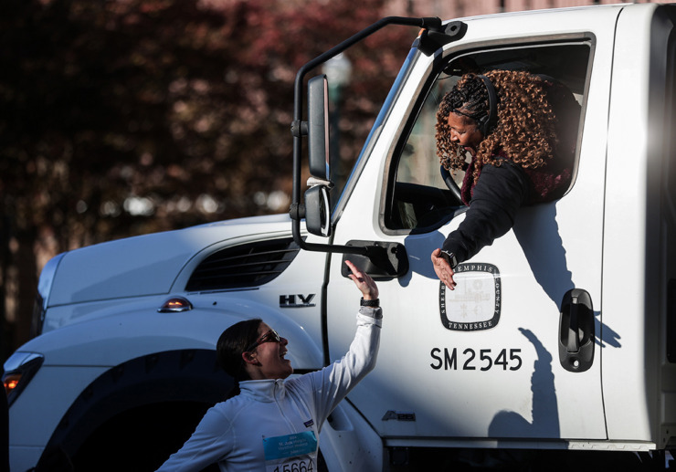 <strong>Victoria Clay high-fives runners during the St. Jude Memphis Marathon on Dec. 7.</strong> (Patrick Lantrip/The Daily Memphian)