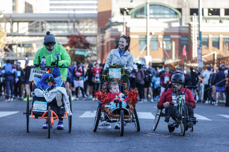 <strong>Alyssa Webb, center, and her son Noah help kick off the St. Jude Memphis Marathon on Dec. 7.</strong> (Patrick Lantrip/The Daily Memphian