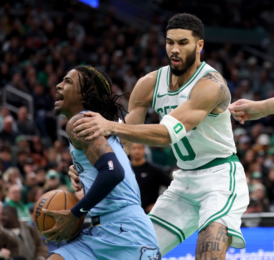 <strong>Boston Celtics forward Jayson Tatum, right, fouls Memphis Grizzlies guard Ja Morant, left, during the first half of an NBA basketball game, Saturday, Dec. 7, 2024, in Boston.</strong> (Mark Stockwell/AP)