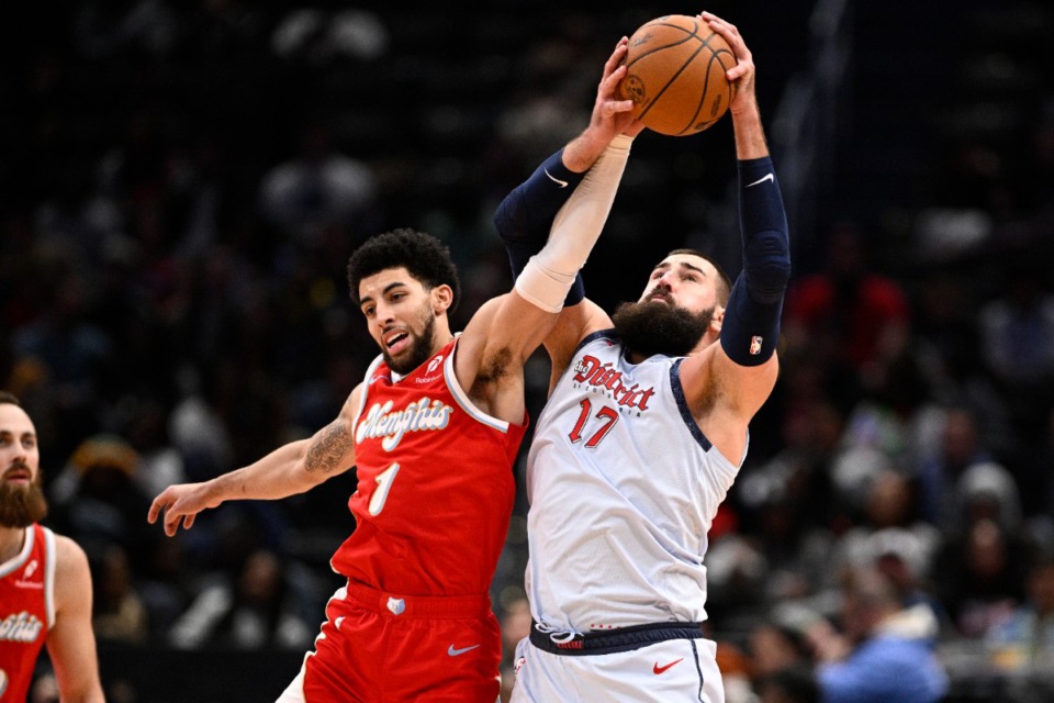 <strong>Washington Wizards center Jonas Valanciunas (17) and Memphis Grizzlies guard Scotty Pippen Jr. (1) battle for the ball during the first half of an NBA basketball game, Sunday, Dec. 8, 2024, in Washington.</strong> (AP Photo/Nick Wass)