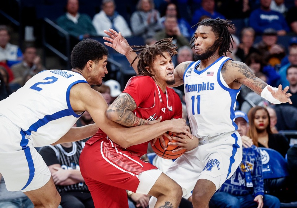 <strong>University of Memphis teammates Nicholas Jourdain (left) and Tyrese Hunter (right) apply pressure to Arkansas State guard Cody Head (middle) on Sunday, Dec. 8, 2024.</strong> (Mark Weber/The Daily Memphian)