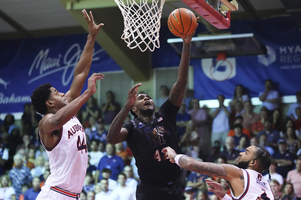 <strong>Memphis forward Dain Dainja (42) can't put in the basket against Auburn center Dylan Cardwell, left, and forward Johni Broome, right, during the first half of the championship game of the NCAA college basketball Maui Invitational tournament Wednesday, Nov. 27, 2024, in Lahaina, Hawaii.</strong> (Lindsey Wasson/AP Photo)