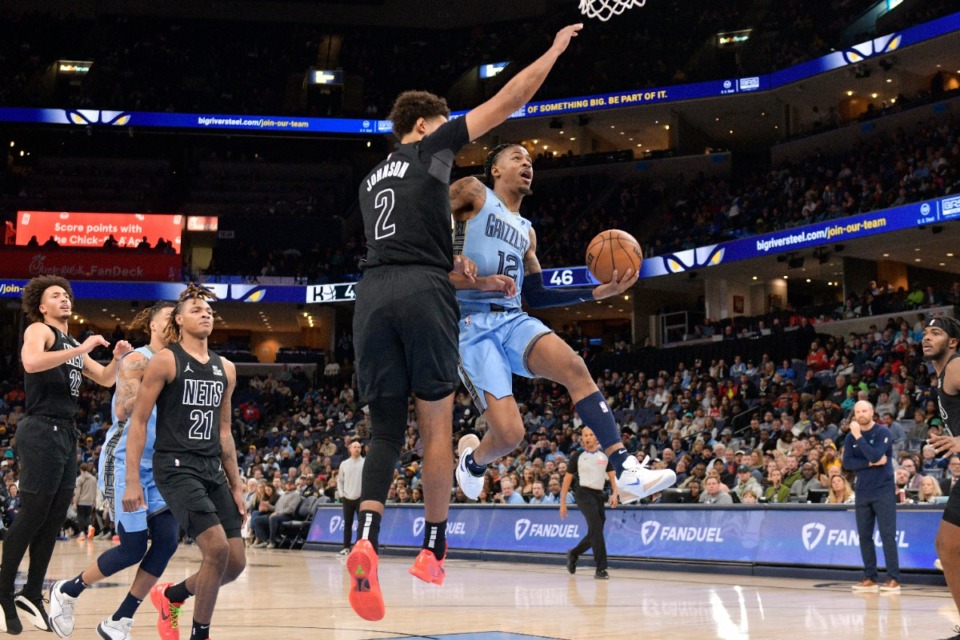 <strong>Memphis Grizzlies guard Ja Morant (12) goes up to shoot against Brooklyn Nets forward Cam Johnson (2) on Friday, Dec. 13, 2024. Morant led the Grizzlies with 28 points.</strong> (Brandon Dill/AP)