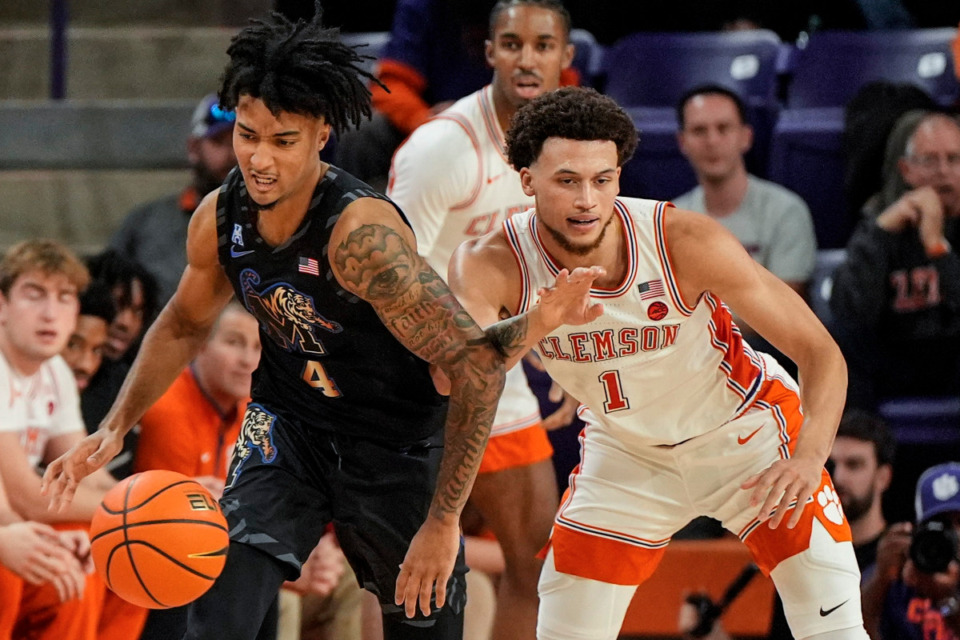 <strong>Memphis guard PJ Haggerty (4) moves against Clemson guard Chase Hunter (1) during the first half of an NCAA basketball game, Saturday, Dec. 14, 2024, in Clemson, S.C.</strong> (AP Photo/Mike Stewart)