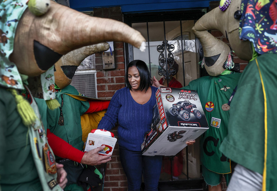 <strong>Tawana Moton (middle) receives gifts for her children from members of the The Secret Order of Boll Weevils for the upcoming holidays on Monday, December 16, 2024.</strong> (Mark Weber/The Daily Memphian)