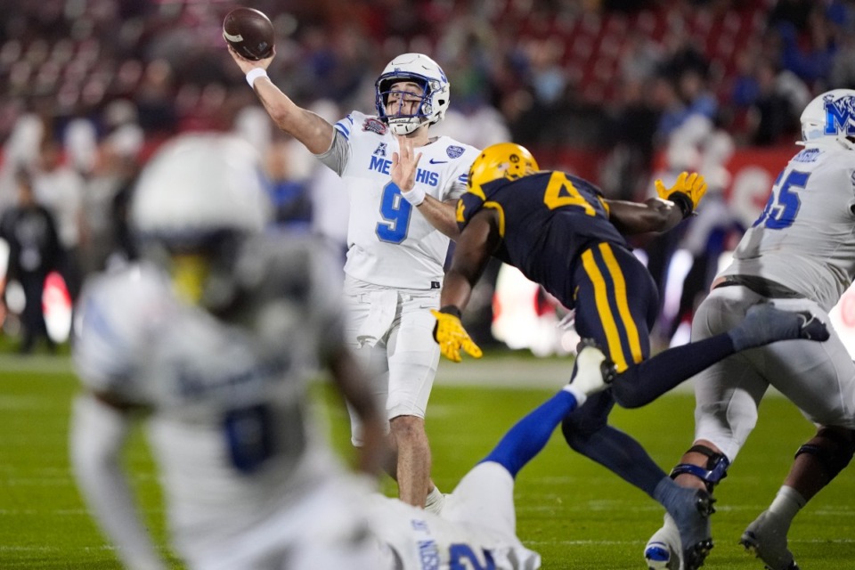 <strong>Memphis quarterback Seth Henigan (9) throws a touchdown pass to wide receiver Demeer Blankumsee under pressure from West Virginia in the Frisco Bowl Tuesday, Dec. 17, 2024, in Frisco, Texas.</strong> (LM Otero/AP)