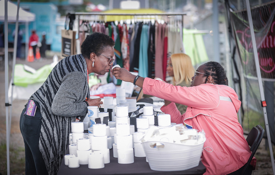 <strong>Ranasha Chapman with M &amp; M Essentials lets a customer smell her shea butters at the Alcy Ball MEMFix in 2023.</strong> (Patrick Lantrip/The Daily Memphian file)