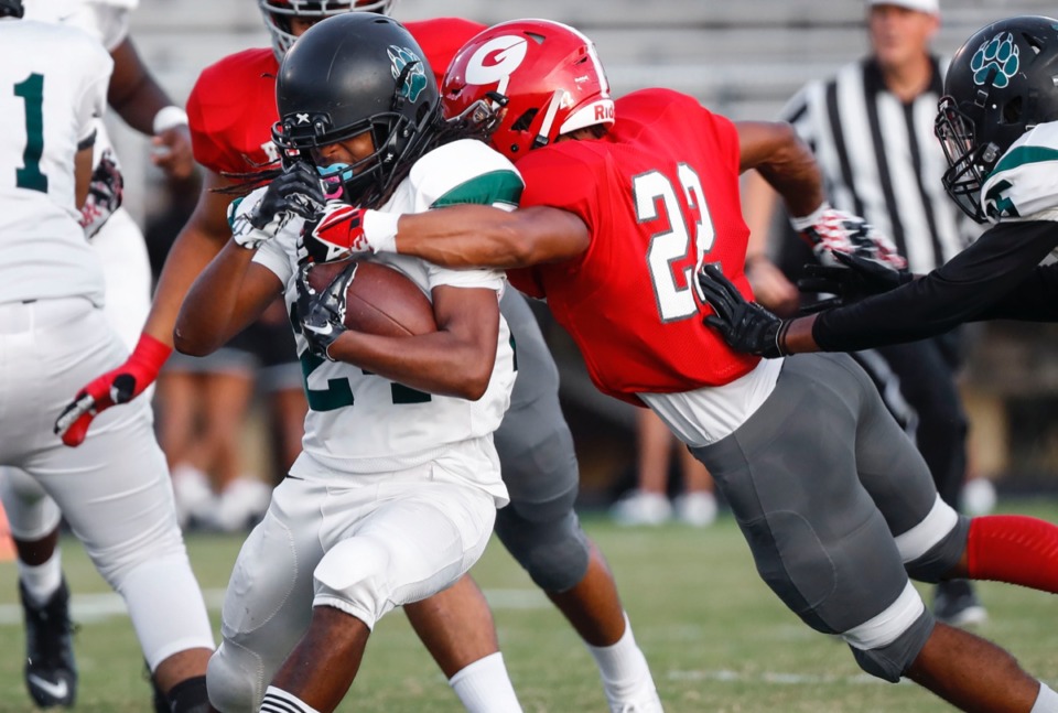 <strong>Germantown defender Marcus Askew (right) brings down Cordova running back Deqwan Bevill (left) Friday, Aug. 30, at Germantown.</strong> (Mark Weber/Daily Memphian)