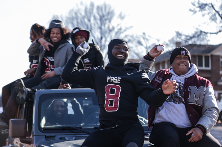 <strong>Members of the MASE football team throw miniature footballs to their classmates during a parade along Poplar Avenue celebrating the school's first state championship Dec. 20.</strong> (Patrick Lantrip/The Daily Memphian)