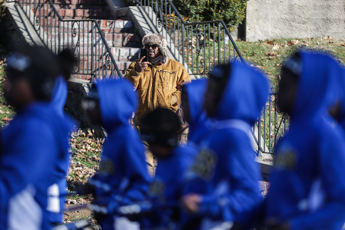 <strong>Onlookers record Dunbar Elementary students marching down Poplar Avenue celebrating MASE's first state championship in football Dec. 20.</strong> (Patrick Lantrip/The Daily Memphian)