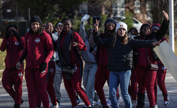 <strong>MASE's women's basketball team marches down Poplar Avenue celebrating the school's first state championship in football Dec. 20.</strong> (Patrick Lantrip/The Daily Memphian)