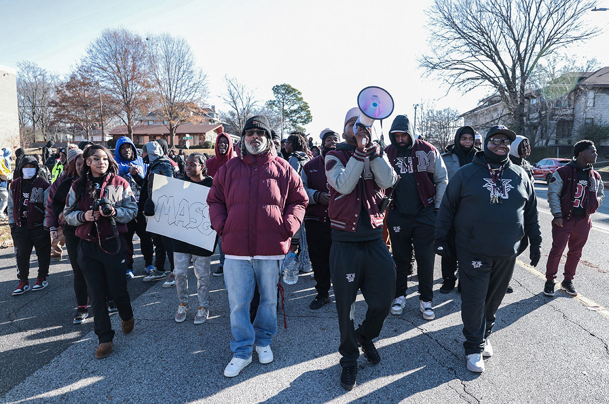 <strong>Members of the MASE football march down Poplar Avenue celebrating the school's first state championship Dec. 20.</strong> (Patrick Lantrip/The Daily Memphian)