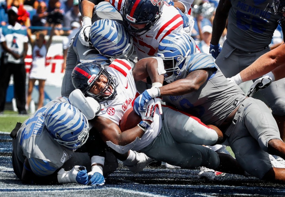 <strong>Ole Miss running back Scottie Phillips (middle) screams as he crosses the goal line for a touchdown against the Memphis defense during action in their NCAA football game at the Liberty Bowl Memorial Stadium Saturday, August 31, 2019.</strong> (Mark Weber/Daily Memphian)