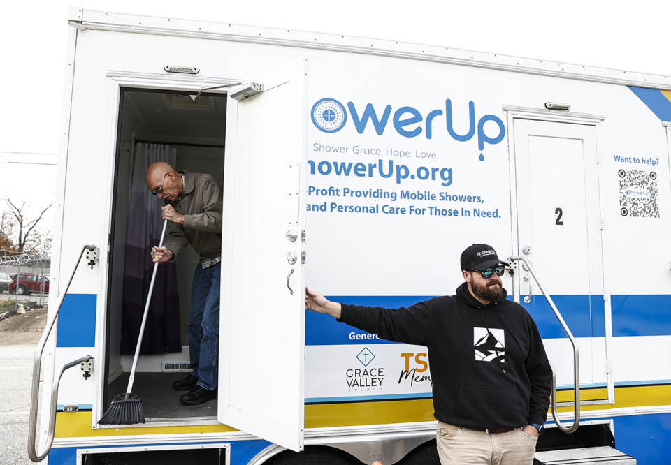 <strong>ShowerUp board of directors member Robert Sloan, right, helps to setup free showers for the homeless community at the Hospitality Hub at 590 Washington Ave.</strong> (Mark Weber/The Daily Memphian)