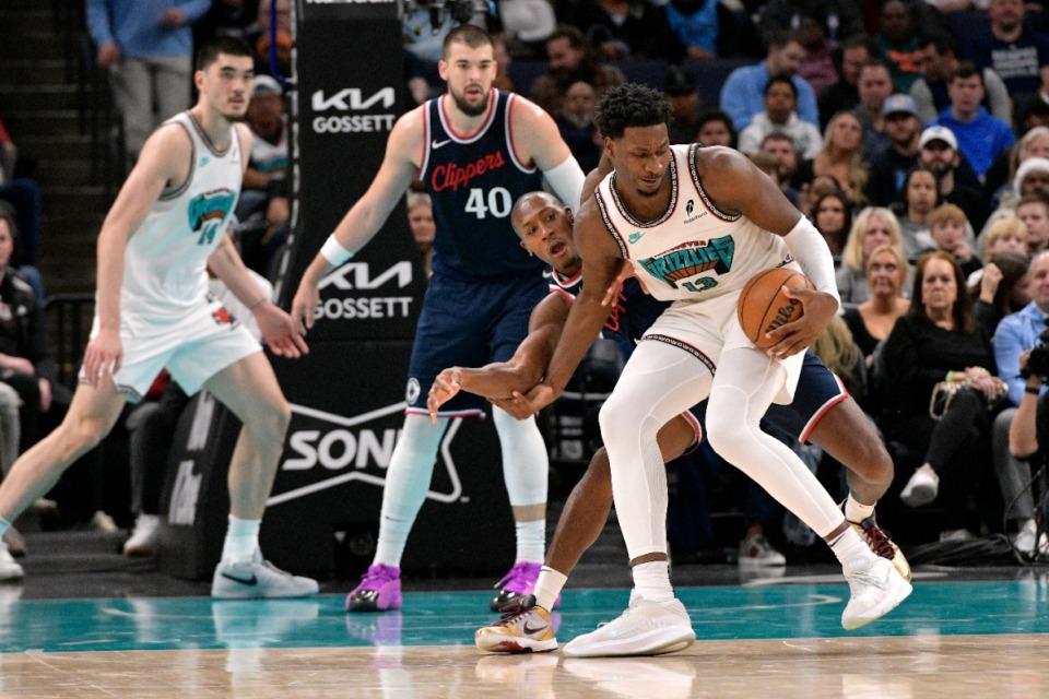 <strong>Memphis Grizzlies forward Jaren Jackson Jr. (13) is degended by Los Angeles Clippers guard Kris Dunn on Dec. 23, 2024. Jackson led the Grizzlies with 24 points.</strong> (Brandon Dill/AP)