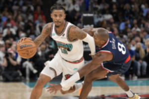 <strong>Memphis Grizzlies guard Ja Morant (12) handles the ball against Los Angeles Clippers guard Kris Dunn (8) on Monday.</strong> (AP Photo/Brandon Dill)