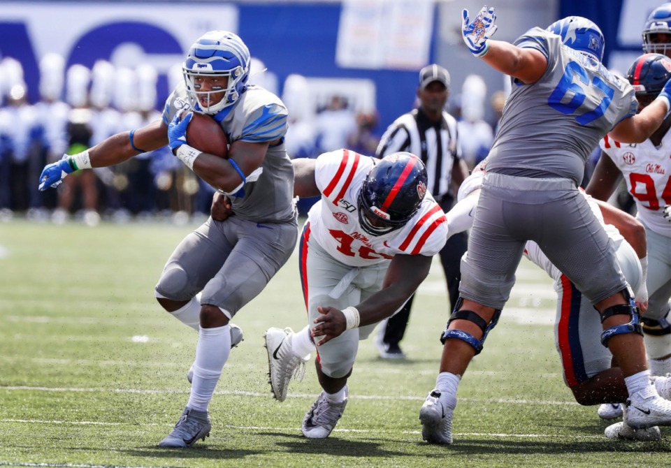 <strong>Memphis running back Kenneth Gainwell (left) scrambles past the Ole Miss defensive for positive yards during action in their NCAA football game at the Liberty Bowl Memorial Stadium Saturday, August 31, 2019.</strong> (Mark Weber/Daily Memphian)