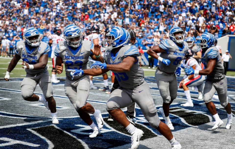 <strong>Memphis defender Bryce Huff (middle) along with his teammates celebrates a sack for a safety against Ole Miss during action in their NCAA football game at the Liberty Bowl Memorial Stadium.</strong> (Mark Weber/Daily Memphian)