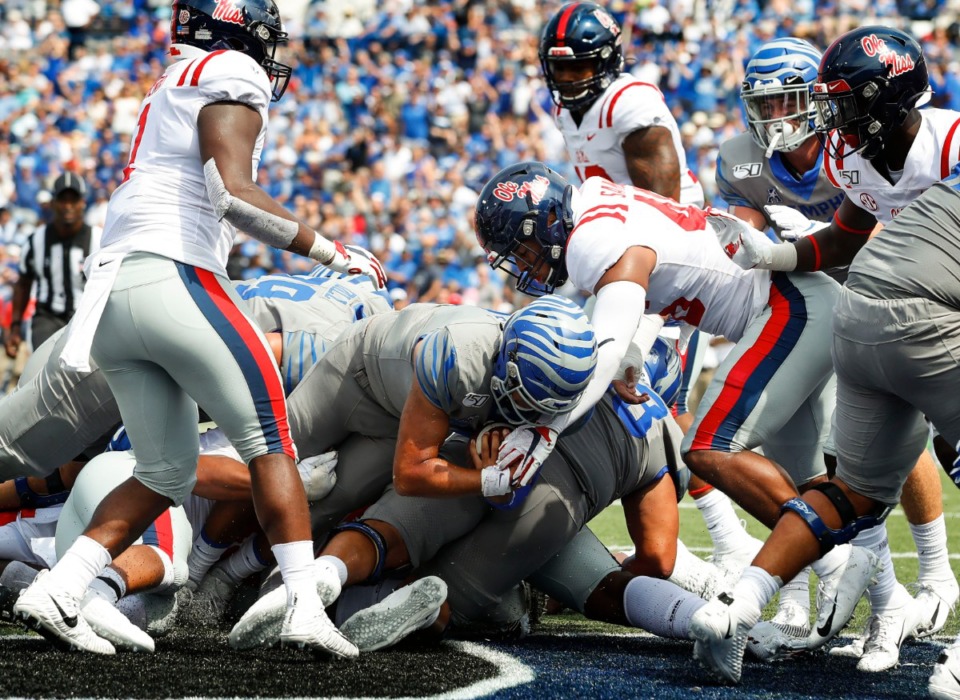<strong>Memphis quarterback Brady White (middle) dives past the Ole Miss defense for a touchdown during action in their NCAA football game at the Liberty Bowl Memorial Stadium Saturday, August 31, 2019.</strong> (Mark Weber/Daily Memphian)
