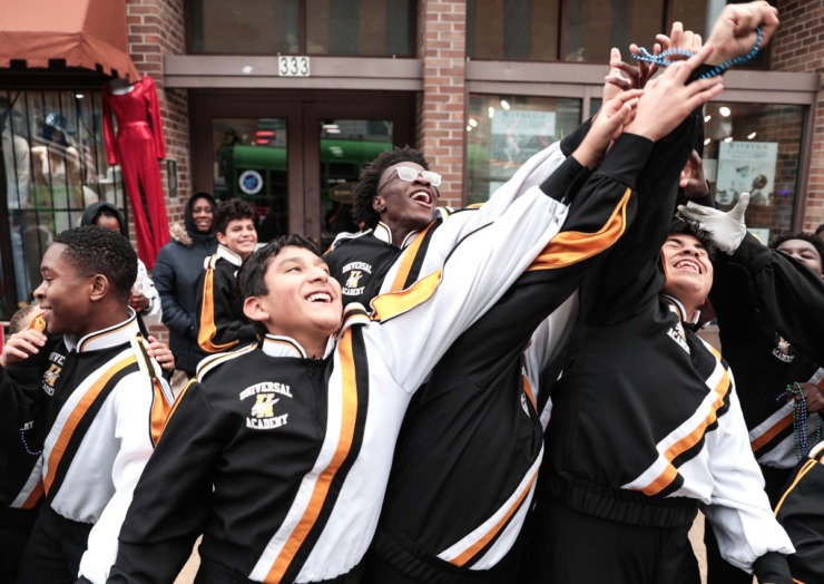 <strong>Members of the Universal Academy marching band jostle for beads during the AutoZone Liberty Bowl Parade Dec. 26, 2024.</strong> (Patrick Lantrip/The Daily Memphian)