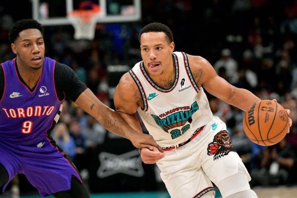 <strong>Memphis Grizzlies guard Desmond Bane (22) handles the ball against Toronto Raptors guard RJ Barrett (9) in the second half of an NBA basketball game Thursday, Dec. 26, 2024, at FedExForoum.</strong> (Brandon Dill/AP)