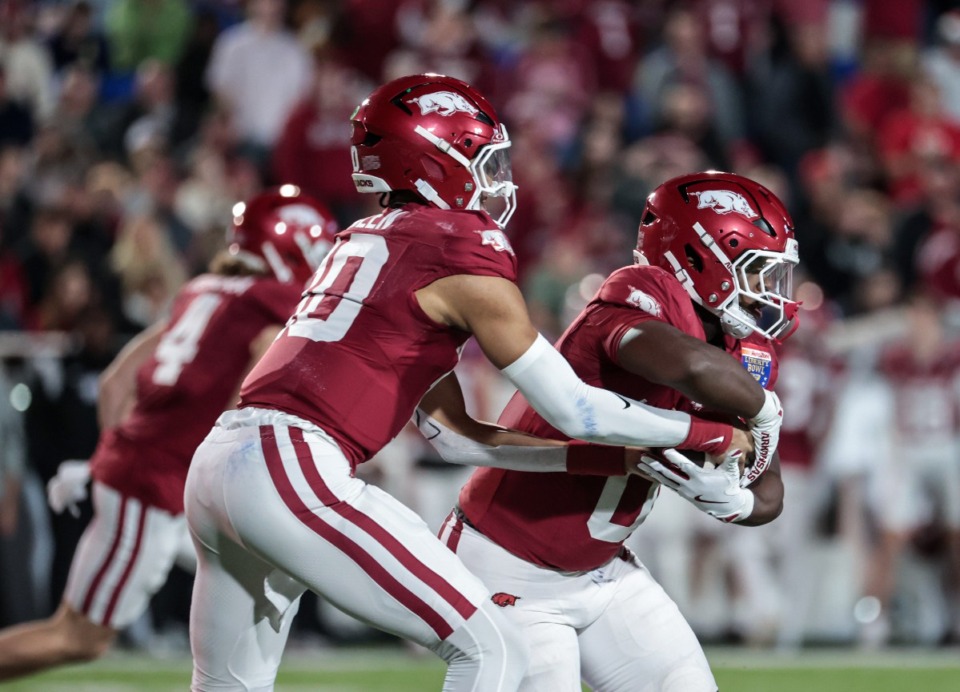 <strong>Arkansas quarterback Taylen Green (10) hands the ball off to running back Braylen Russell (0) during the AutoZone Liberty Bowl Dec. 27, 2024.</strong> (Patrick Lantrip/The Daily Memphian)