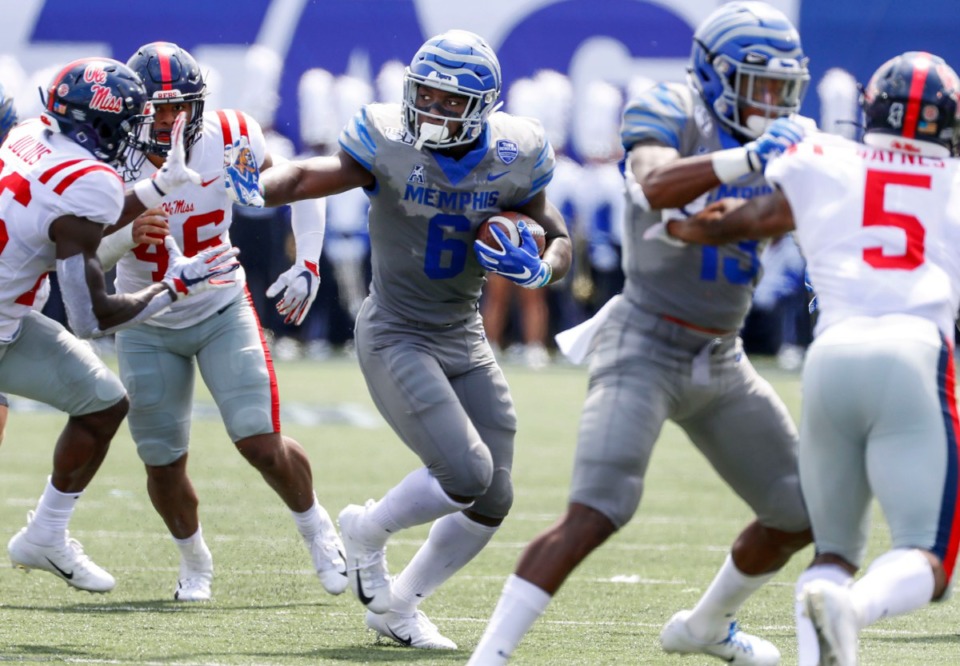 <strong>Memphis running back Patrick Taylor Jr. (middle) scrambles past the Ole Miss defense for positive yards during action in their NCAA football game at the Liberty Bowl Memorial Stadium Saturday, August 31, 2019.</strong> (Mark Weber/Daily Memphian)
