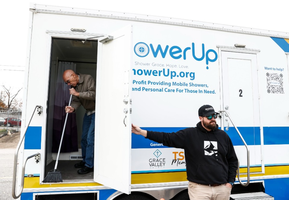 <strong>ShowerUp board of directors member Robert Sloan, right, helps to setup free showers for the homeless community at the Hospitality Hub at 590 Washington Ave.</strong> (Mark Weber/The Daily Memphian)