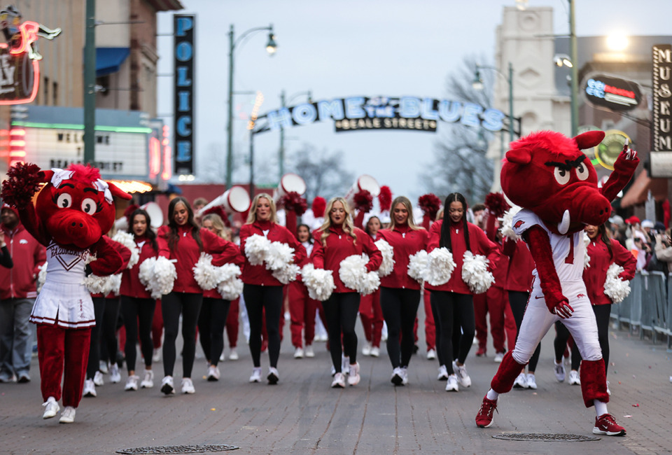 <strong>The Arkansas Razorbacks cheer team makes its way down Beale Street during the AutoZone Liberty Bowl Parade Dec. 26, 2024.</strong> (Patrick Lantrip/The Daily Memphian)