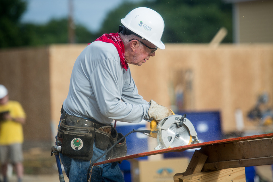 <strong>Former President Jimmy Carter cuts a piece of plywood at a Memphis Habitat for Humanity homebuilding site inside the Bearwater Creek development in Uptown in 2015.</strong> (The Daily Memphian files)