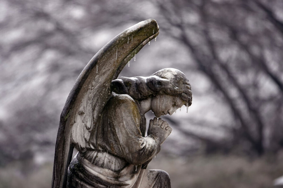 <strong>Icicles drip from a frozen angel in prayer at Elmwood Cemetery in Memphis on Feb. 13, 2021.</strong> (Karen Pulfer Focht/Special to The Daily Memphian)