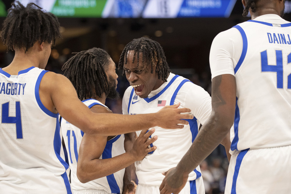 <strong>Memphis guard PJ Haggerty (4), guard Tyrese Hunter (11), guard Baraka Okojie, third from left, and forward Dain Dainja, right, gather to celebrate a scoring run against North Texas during the first half of an NCAA college basketball game Sunday, Jan. 5, 2025, in Memphis.</strong> (Nikki Boertman/AP Photo)