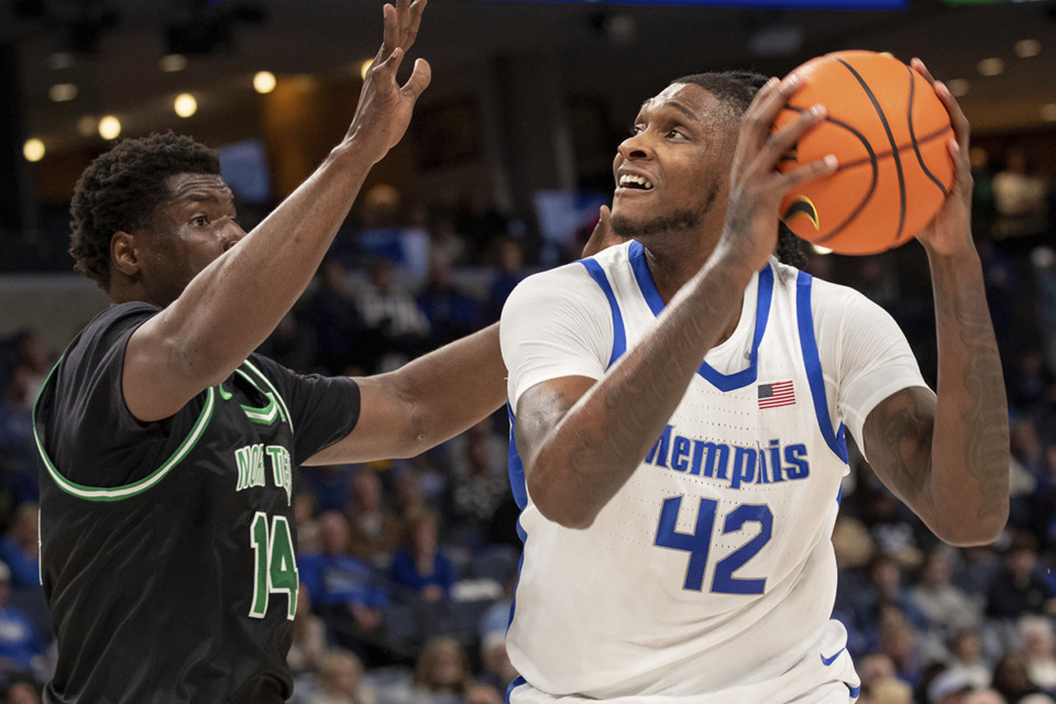 <strong>North Texas forward Moulaye Sissoko (14) defends against a shot-attempt by Memphis forward Dain Dainja (42) during the first half of an NCAA college basketball game Sunday, Jan. 5, 2025, in Memphis.</strong> (Nikki Boertman/AP Photo)