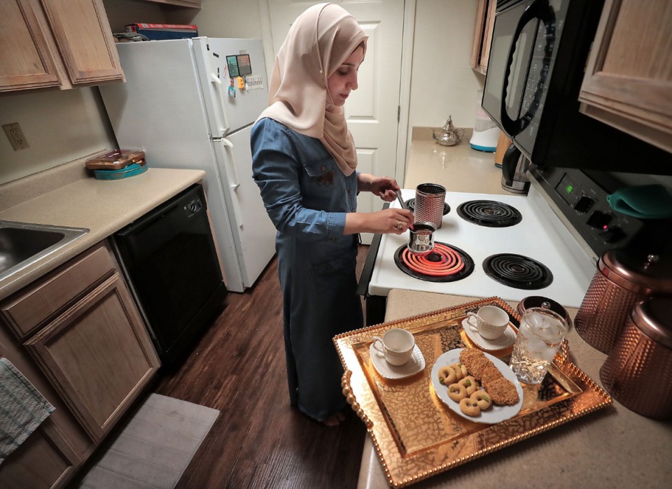 <strong>Walaa Labash makes coffee on Aug. 14, 2019, at the Lakeland apartment where she lives with her family. Walaa and her husband Mohammad Almasalma left Syria at the start of that country's civil war, and over the course of a decade have lived in three different countries, with a child born in each.</strong> (Jim Weber/Daily Memphian)