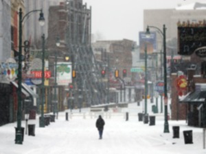 <strong>A lone man walks down the center of a snowy Beale Street in Memphis.</strong> (Patrick Lantrip/The Daily Memphian file)&nbsp;