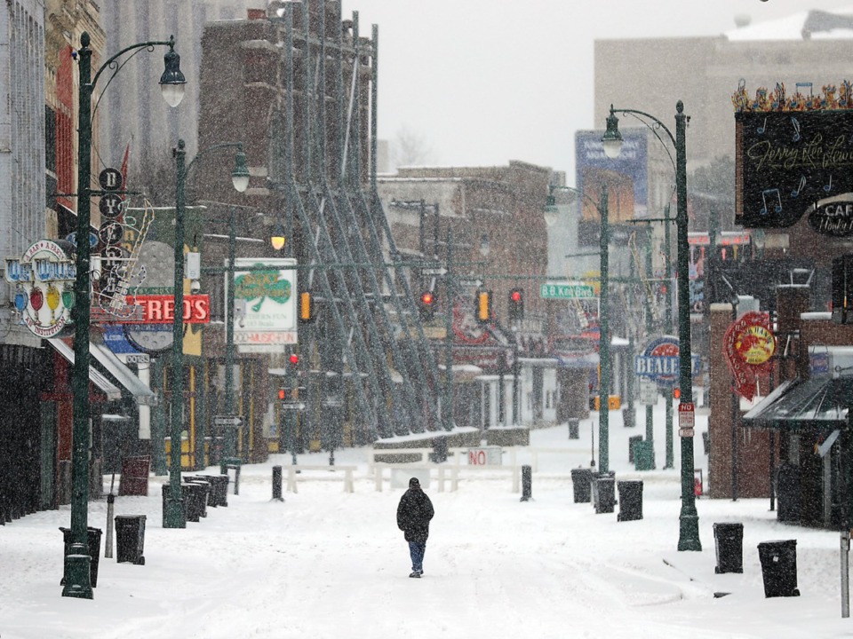 <strong>A lone man walks down the center of a snowy Beale Street in Memphis.</strong> (Patrick Lantrip/The Daily Memphian file)&nbsp;