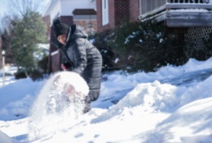 <strong>A woman shovels snow from her driveway Jan. 16, 2024.</strong> (Patrick Lantrip/The Daily Memphian file)