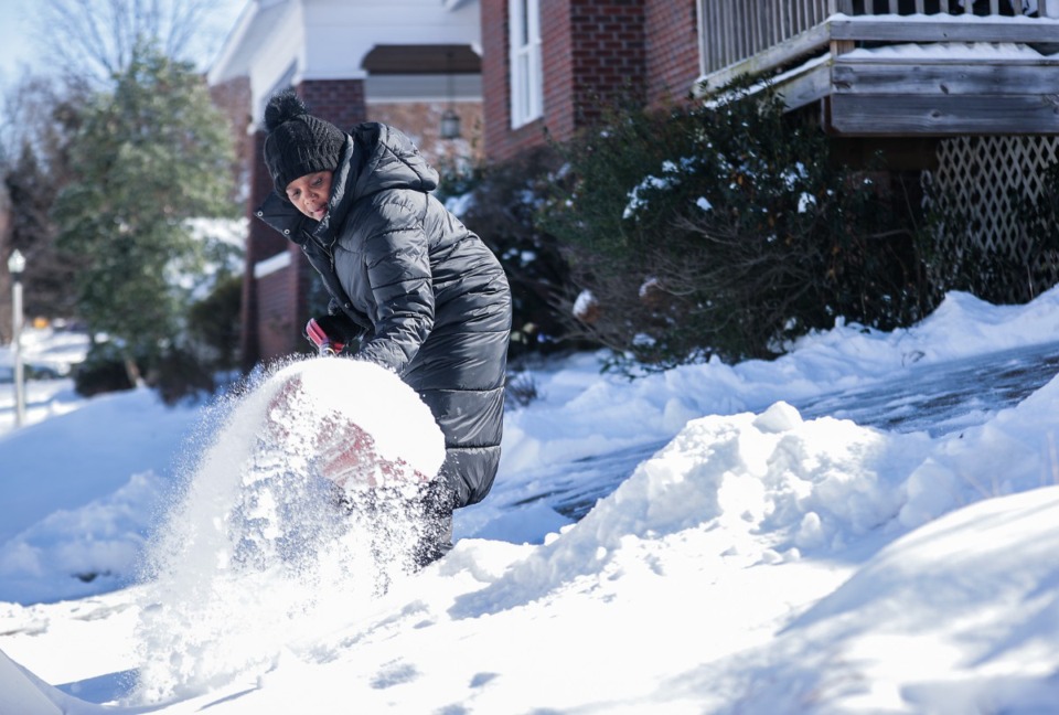 <strong>A woman shovels snow from her driveway Jan. 16, 2024.</strong> (Patrick Lantrip/The Daily Memphian file)