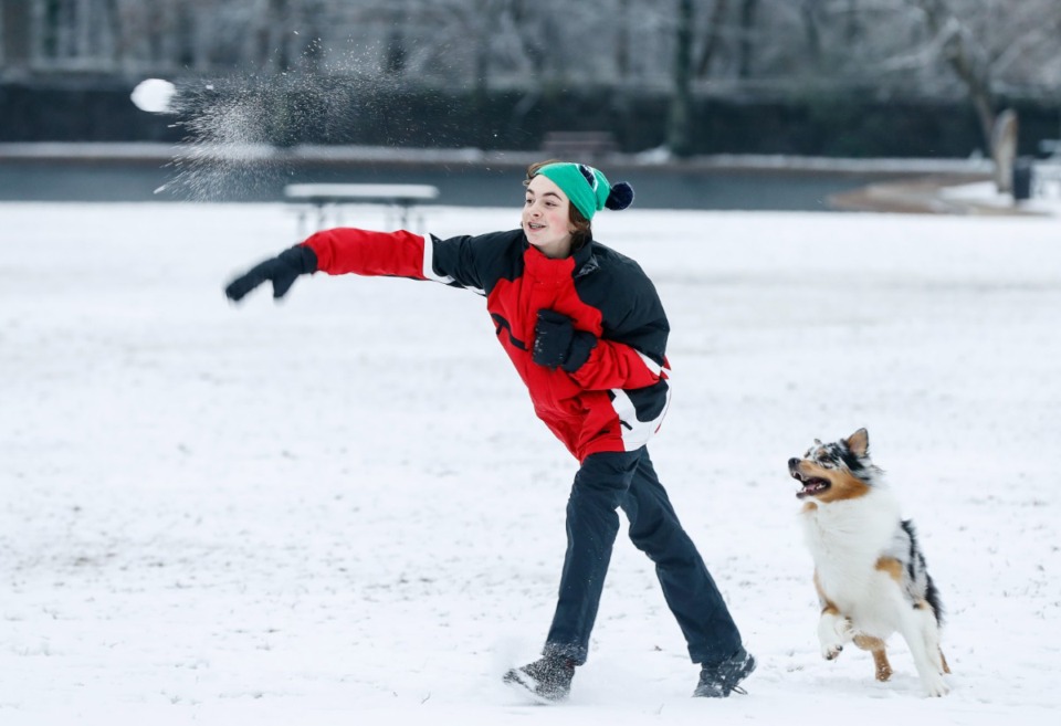 <strong>JW Curry throws snowballs in snow clad Overton Park on Sunday, Jan. 16, 2022.</strong> (Mark Weber/The Daily Memphian file)