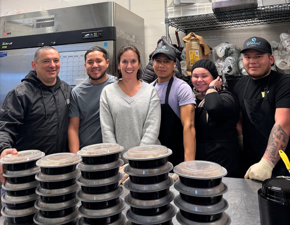 <strong>Global Caf&eacute; team members pack up meals in the Crosstown kitchen to deliver to neighbors in need. From left: Juan, Camila, Sabine, Johnny, Maria and Rolando.</strong> (Submitted)